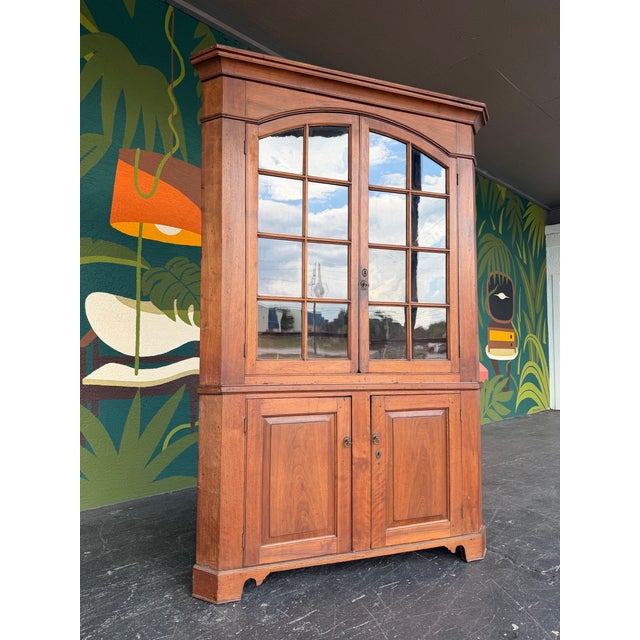 Beautiful two-piece Early American Chippendale style corner cabinet. Constructed from solid wild cherry wood featuring...