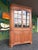 Beautiful two-piece Early American Chippendale style corner cabinet. Constructed from solid wild cherry wood featuring...