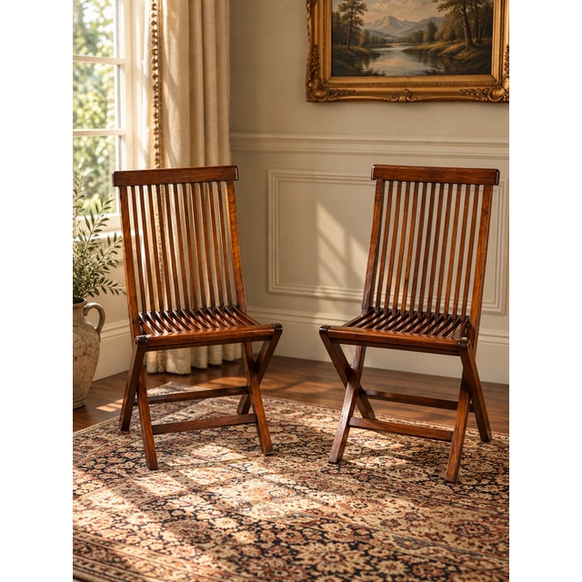 This handsome pair of vintage folding chairs embodies the clean architectural lines and understated elegance associated...