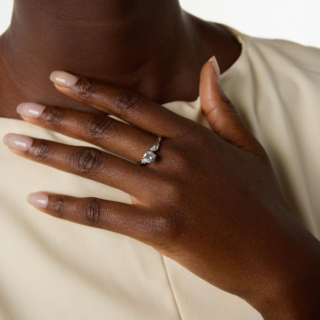 A timeless vintage engagement ring showcasing a brilliant round cut diamond weighing approximately 0.95 carat at its...
