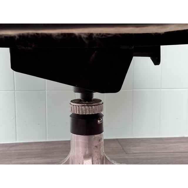 Vintage Office Armchair made in Italy in the 70s. Steel base with 4 wheels for movement. Padded seat covered in black...