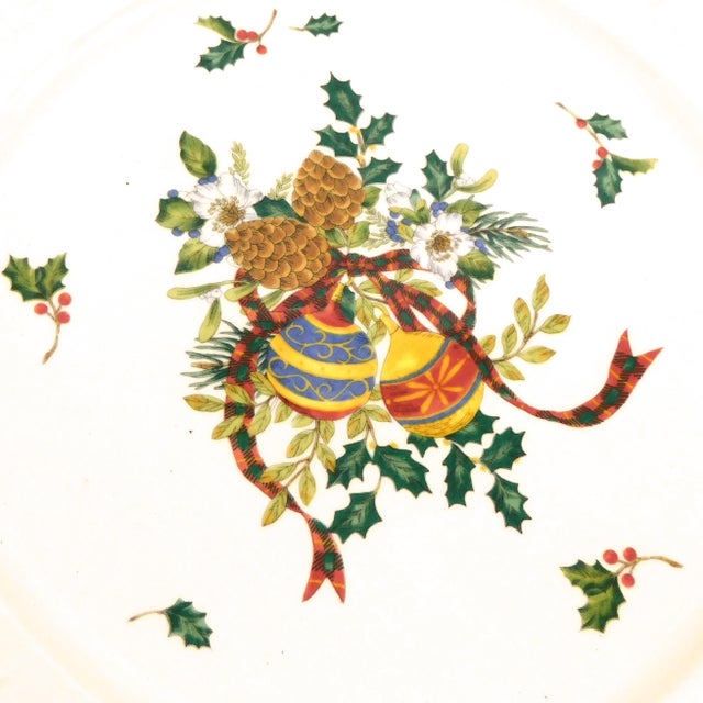This is a Mikasa round platter in Holiday Season from 1996. The platter is white with a oranment and holly center, green...