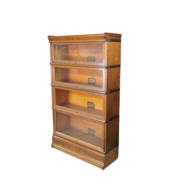 A classic and highly sought-after Antique Globe Wernicke Mission Style Stacking Barrister Bookcase, standing approximately...