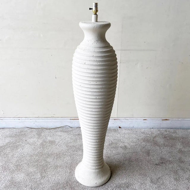 Exceptional vintage 1980s postmodern ceramic floor lamp. Features an off white ribbed body.