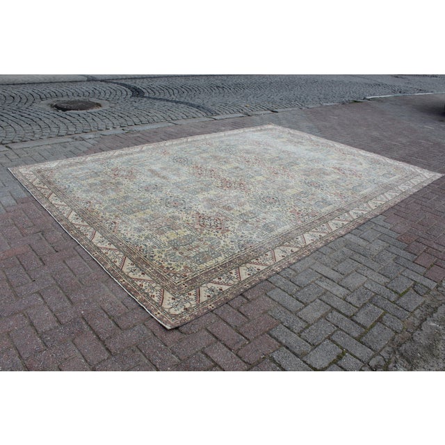 This beautiful, traditional vintage, hand knotted Turkish area rug is approximately 60 years old. It is handmade of very...