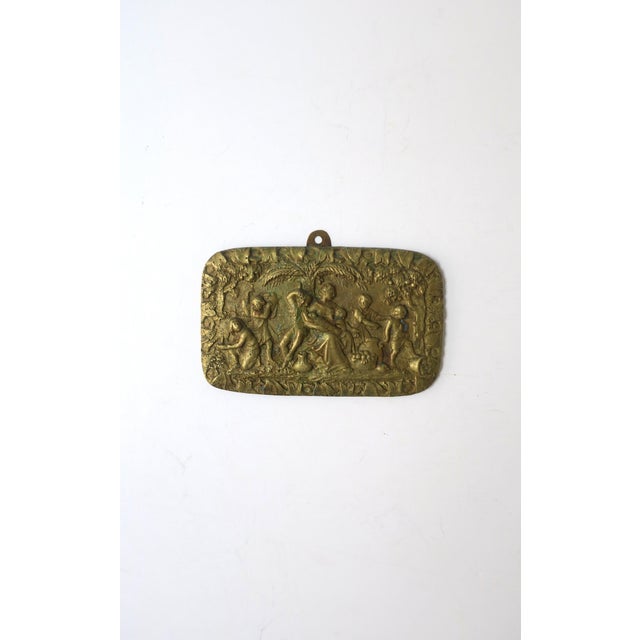 A French gilt‑bronze relief wall art piece depicting a woman and family scene within a lush garden setting, Neoclassical...