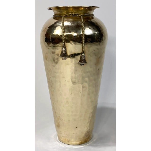 Tie it up! Vintage tall hammered brass urn vase featuring rope and tassel detail. Interior opening measures 3.75"...