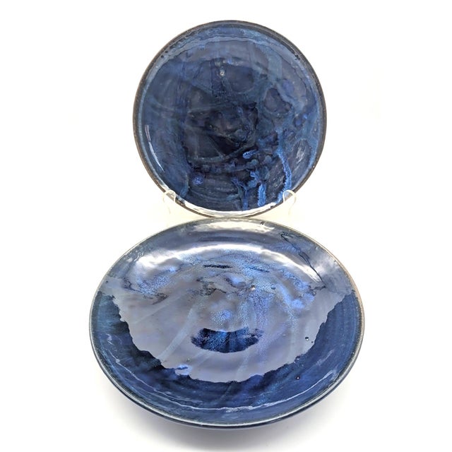 Offered are 2 wheel-thrown studio pottery stoneware decorative plates featuring a blue rutile glaze finish. Their maker's...