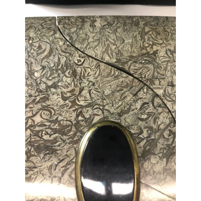 Unique rosewood box designed with a modernist slide drawer. Solid brass ball feet and a black stone knob. Exquisite...