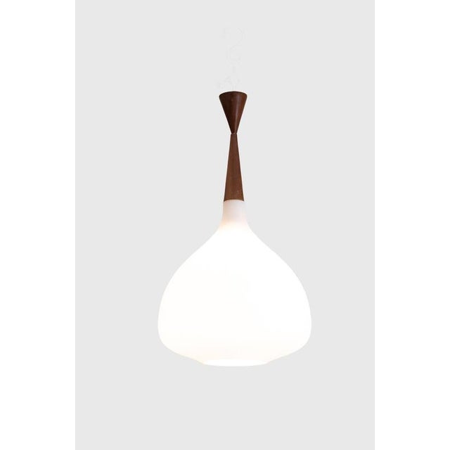 Suspension in White Opaline Glass and Blond Mahogany, 1960s, in Good conditions. This piece is designed in the style of...