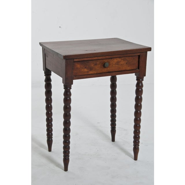 Small side table having a single drawer and four turned legs. Probably made in America around 1840.