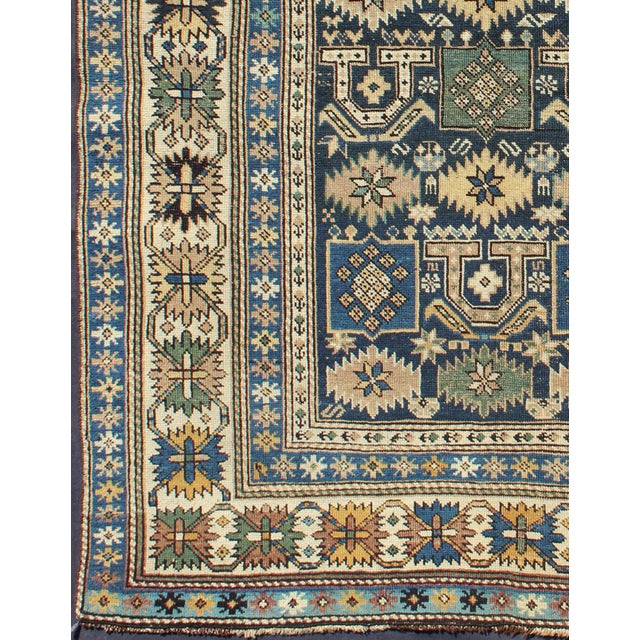 Measures: 3'3'' x 4'5''. The field of this Caucasian piece features all-over tribal motifs and shapes decorated with small...