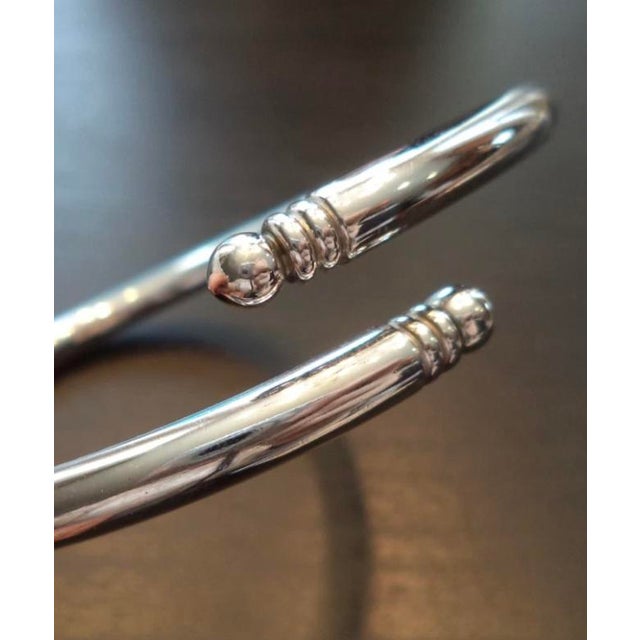 This rare 1980s Contemporary Silver Monet Wrap Bangle will be a lovely addition to your vintage jewelry collection. The...