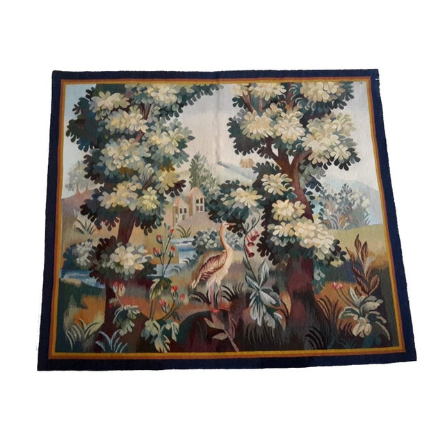 This is a beautiful handmade tapestry depicting a large bird in a charming garden setting. The background features trees,...