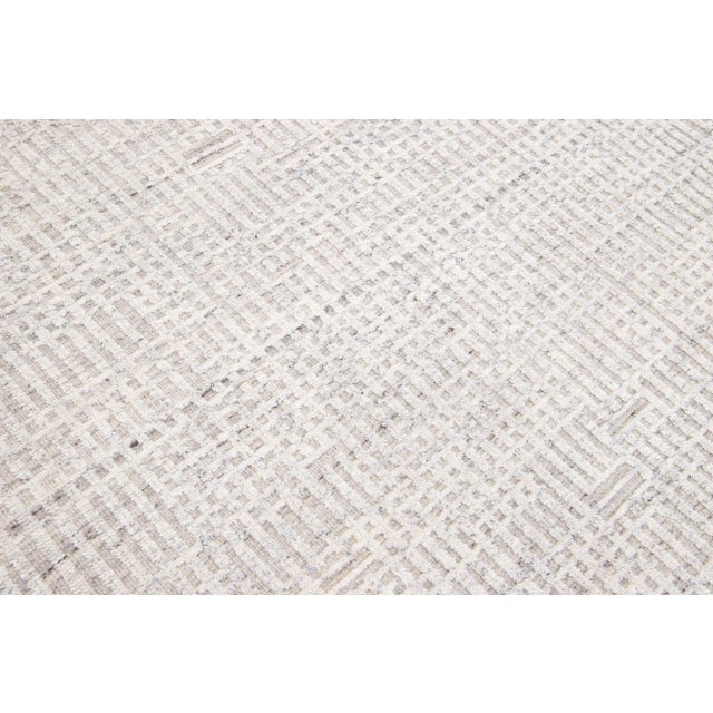 Beautiful modern Moroccan-style hand-knotted wool rug with a beige color field. This rug is part of our Apadana's Safi...