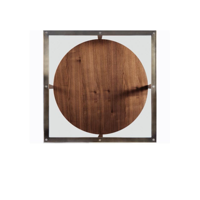 The "Manhattan" cocktail table is a beautiful combination of walnut, Bronze, and glass. The round form of the walnut shelf...