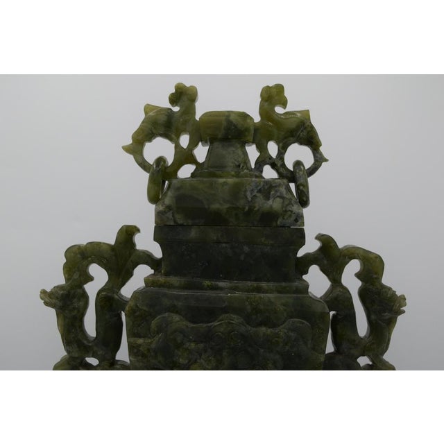 China - Large green serpentine covered vase with carved bas-relief decoration of tao-tié. Stylized dragon-shaped handles...