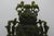 China - Large green serpentine covered vase with carved bas-relief decoration of tao-tié. Stylized dragon-shaped handles...