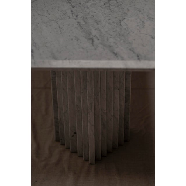 Large architectural white marble dining table. Made out of two sculptural solid marble bases and a rectangular shaped...