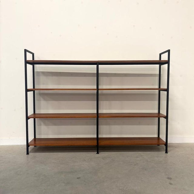 Remarks: Bookcase, shelves / room divider with steel frame and teak veneer shelves, 1960s. This wall unit is in very good...