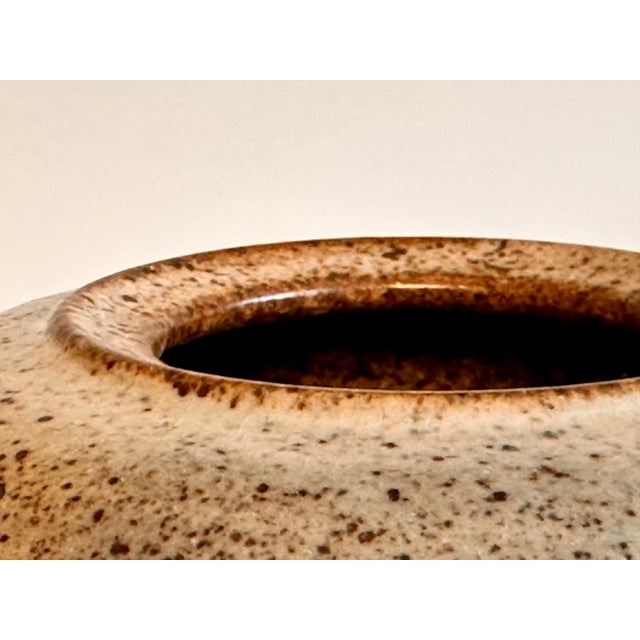 This unsigned, handmade ceramic vase from the 1980s captivates with its serene, cylindrical form and a characteristic,...