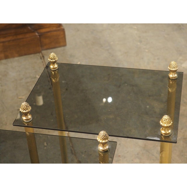 More information coming soon… This pair of French side tables, with two tiers of smoked glass, paired with gilt brass legs...
