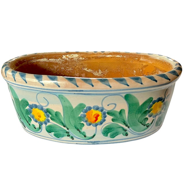A beautifully hand-painted Italian cachepot / planter by Vietri featuring a cheerful scrolling floral motif in vibrant...