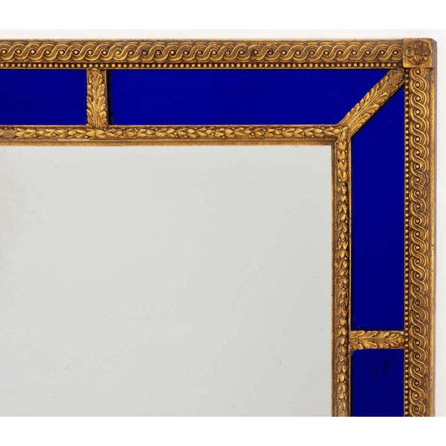 Swedish Baroque Style Giltwood Framed Cushion-Cut Mirror, with cobalt blue glass panels surrounding central rectangular...
