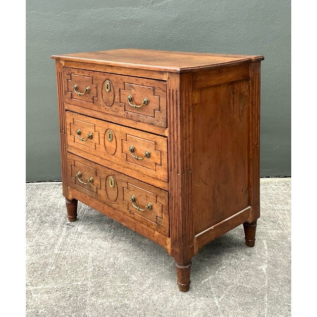 This elegant vintage chest of drawers is a masterful interpretation of French Provincial design, blending the formal...