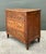This elegant vintage chest of drawers is a masterful interpretation of French Provincial design, blending the formal...