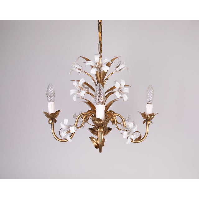 Introducing a luxurious collection of gilt chandeliers with white enamel lily flowers. Perfect for hallways, dining rooms,...