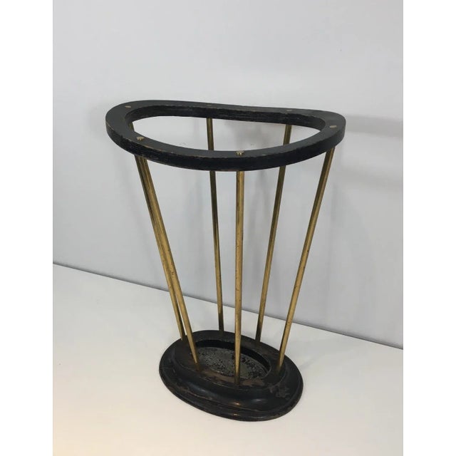 Attributed to Jacques Adnet. Ebonized wood and brass umbrella stand. French, circa 1950.