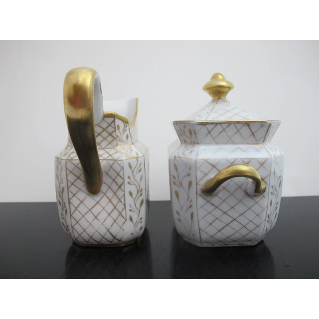 Beautiful French style porcelain creamer and sugar set. White porcelain with gold gilt basket weave design and colorful...