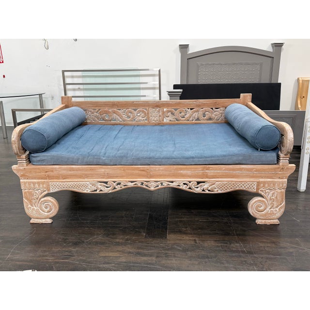 Design Plus Gallery presents a Vintage Hand-Carved Teak Daybed. The solid wood structure displays extensive hand-carved...