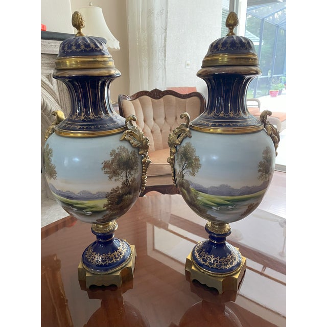 Add timeless European elegance to your home with this stunning pair of hand-painted porcelain vases. Crafted in the lavish...