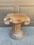 A sculptural carved wood pedestal inspired by the architectural vocabulary of the ancient world. The form references a...