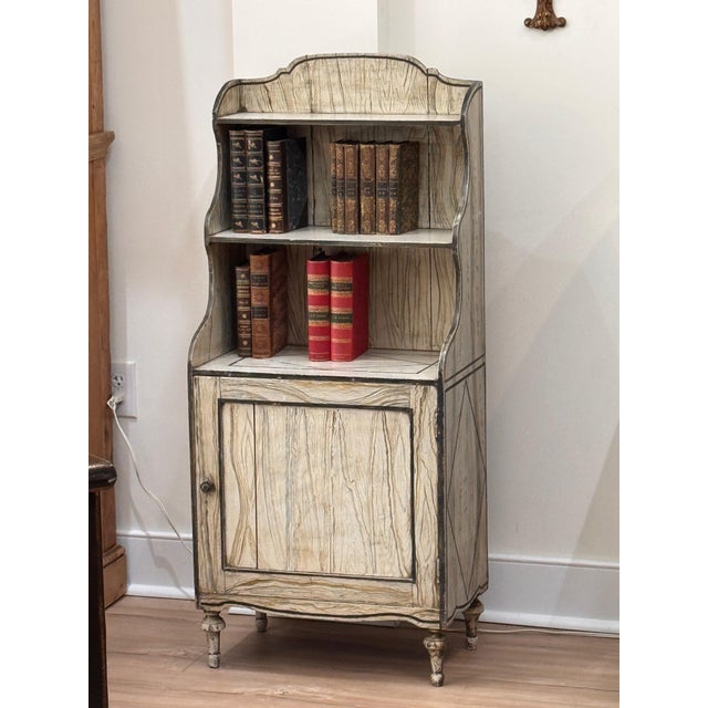Avery charming early 19th C. English diminutive waterfall-form bookcase with open upper shelving and a single-door...