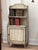 Avery charming early 19th C. English diminutive waterfall-form bookcase with open upper shelving and a single-door...