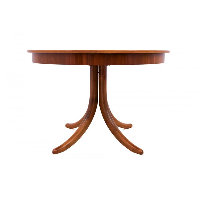 An elegant round table from mid-20th century Germany, distinguished by its harmonious form and striking design. Crafted...