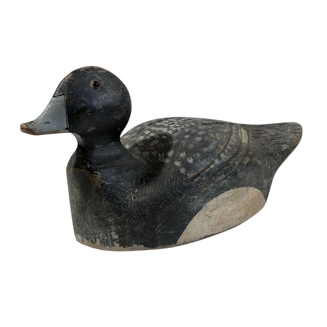 Vintage 20th century hand-carved and hand-painted solid wood Old Bluebill duck decoy. This substantial piece measures...