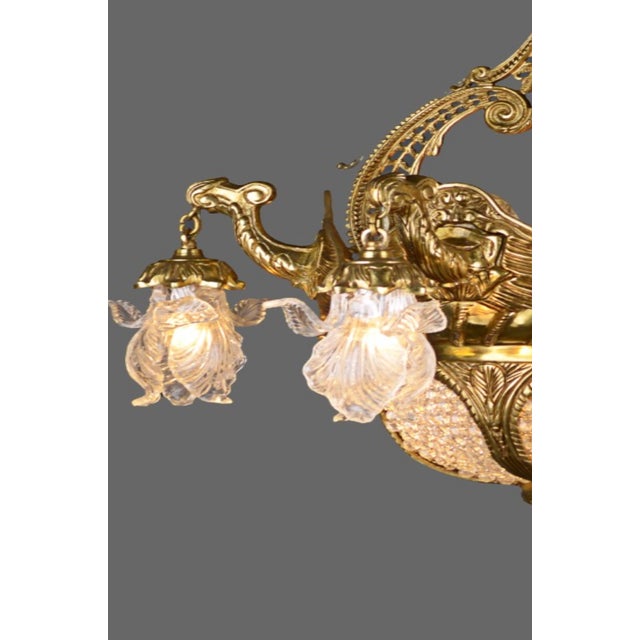 Bring a touch of timeless grandeur to your interiors with this vintage 1990 French Louis XVI-style chandelier, masterfully...
