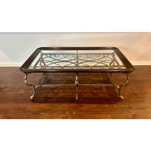 This striking Klaussner coffee table has a cast aluminum metal base, highlighted with leaf motifs on each footed leg and...