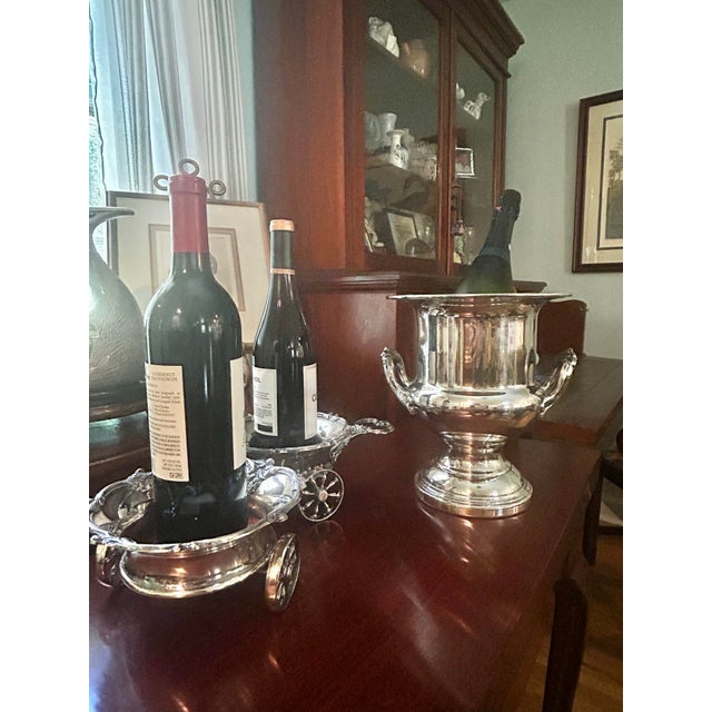 This is a handsome vintage silver-plated champagne cooler featuring a classic trophy silhouette with elegant cast scroll...