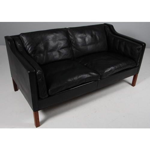 Børge Mogensen two-seat sofa with original black leather upholstery. Legs of teak. Model 2212, made by Fredericia...