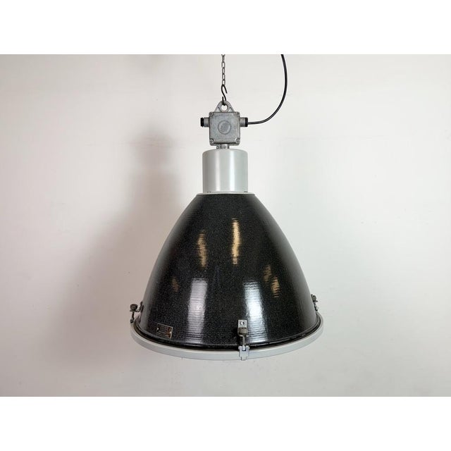 Industrial black ( dark grey ) enamel pendant lamp designed and produced by Elektrosvit in former Czechoslovakia during...