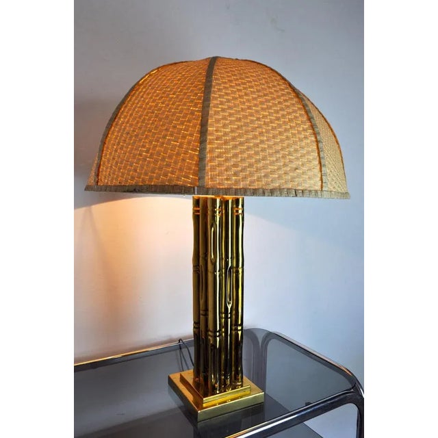 Superb and rare brass table lamp imitating bamboos. Rattan lampshade. Superb design from France in the 1970s in the style...