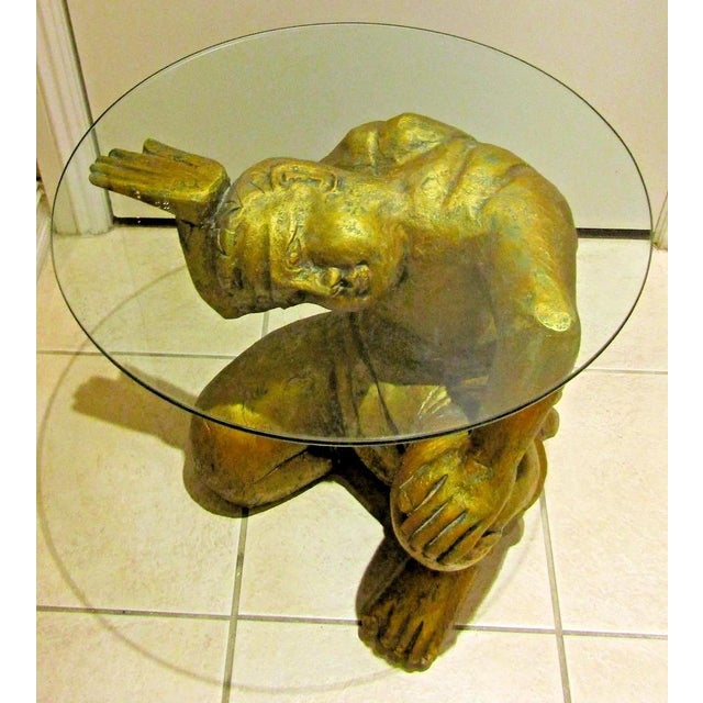 This Vintage Gilded Carved Wood Asian Figural Side Table with Glass Top is a unique and exquisite piece of furniture from...