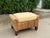 Vintage banana leaf ottoman with a substantial woven frame, tapered wood feet, and a removable upholstered cushion. The...