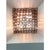 Elegant contemporary wall sconces made in amber-rosè murano glass “squared” elements. “squared ” are blown inside a wooden...