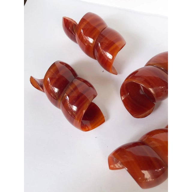 Delightful set of six retro chic twisted curl napkin rings in a deep and glossy amber butterscotch hue with tiger eye...